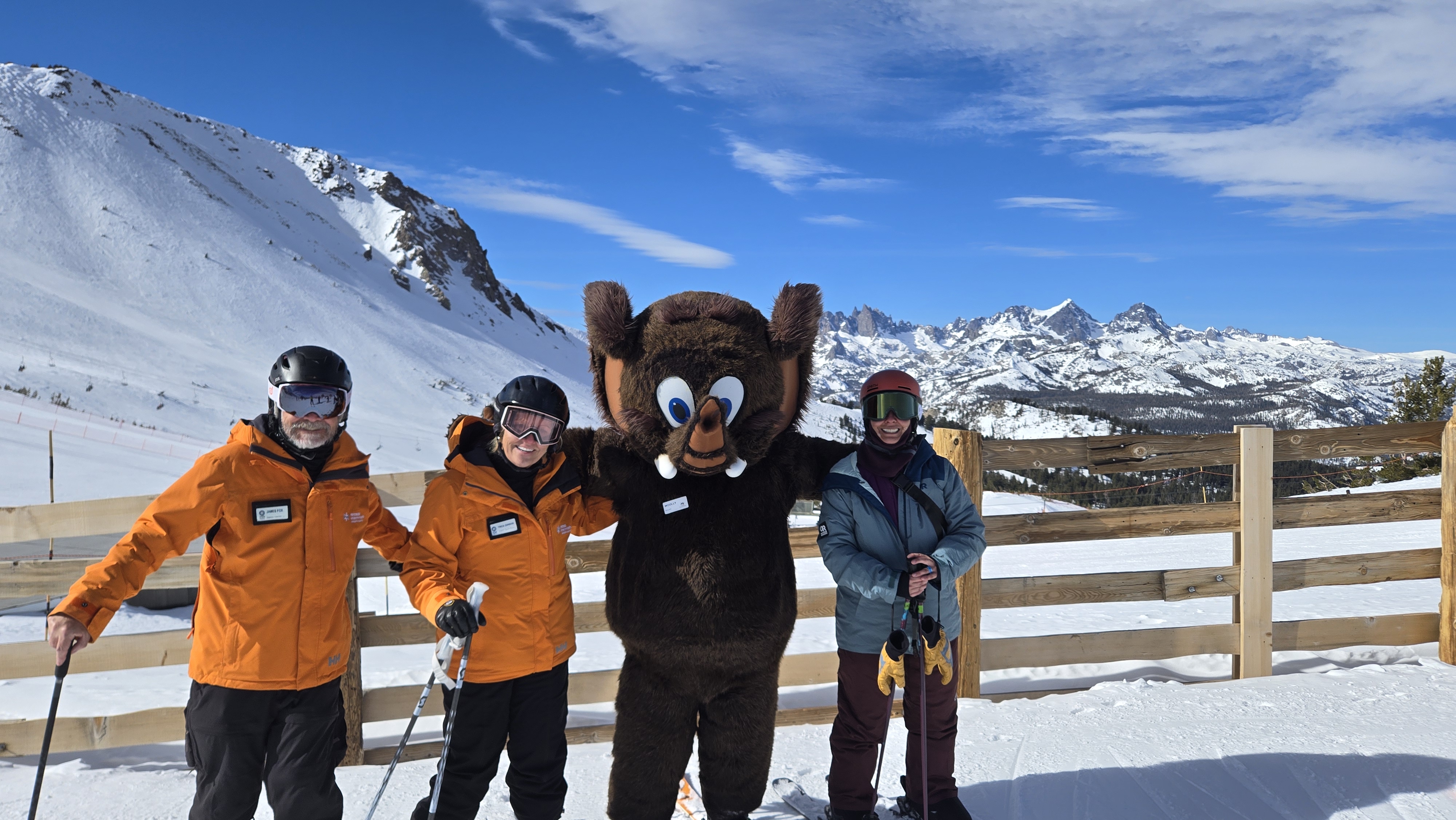 image An Access Mammoth instructor with athlete road biking down a highway smiling at the camera