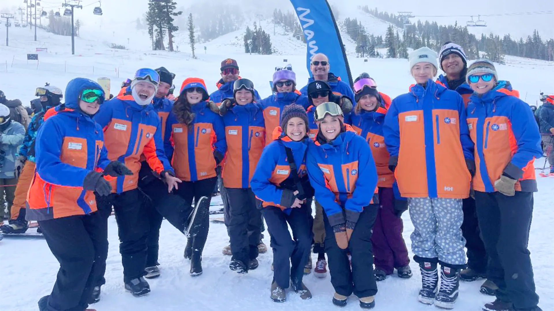 image An Access Mammoth instructor with athlete road biking down a highway smiling at the camera
