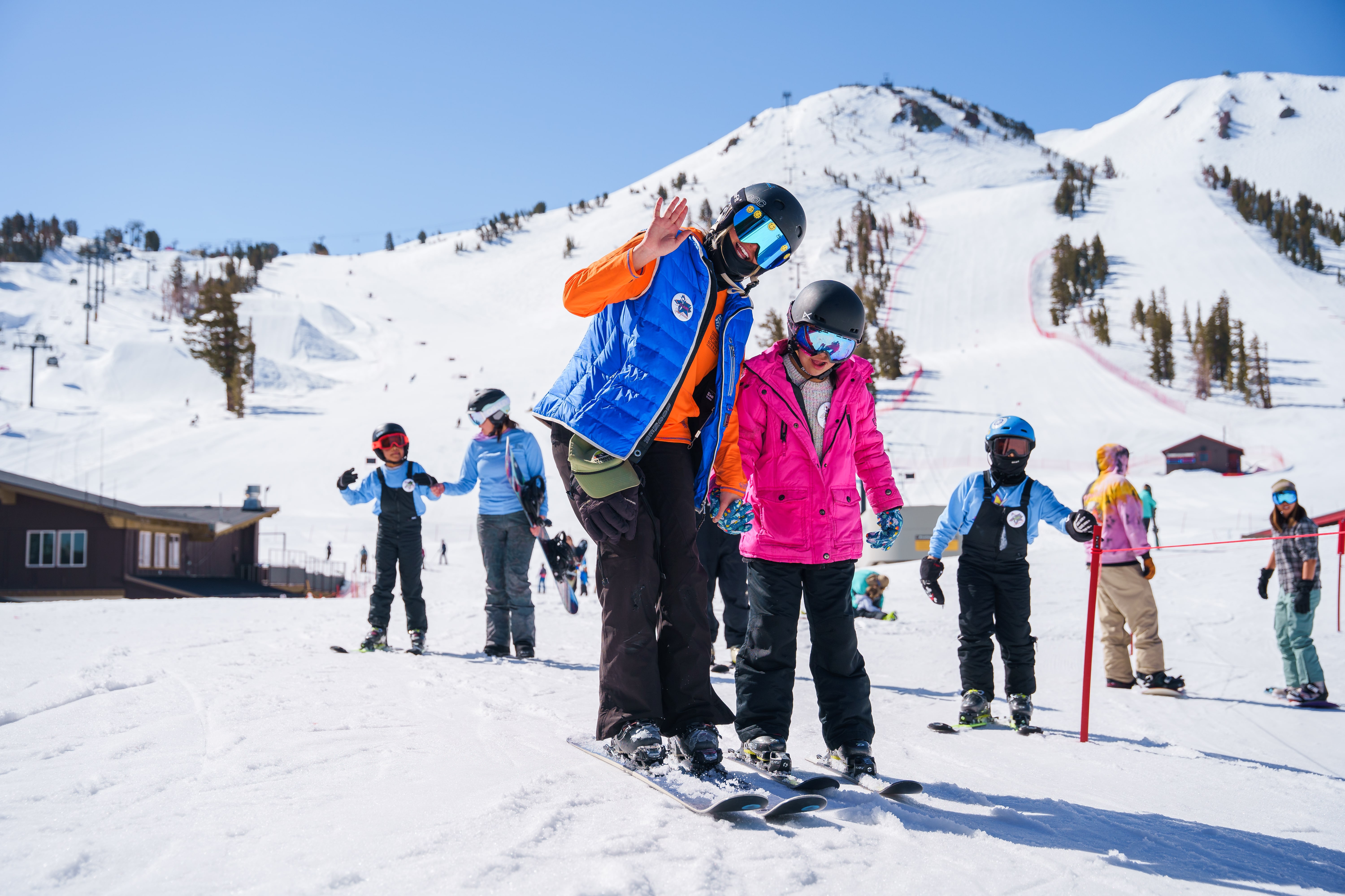image An Access Mammoth instructor with athlete road biking down a highway smiling at the camera