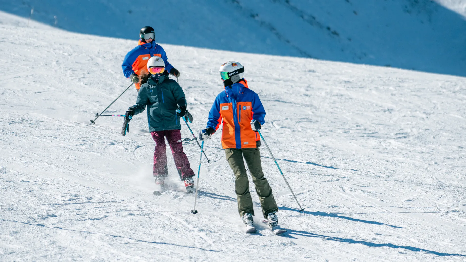 An Access Mammoth athletes skiing down a snowy mountain during one of our winter programs with an instructor