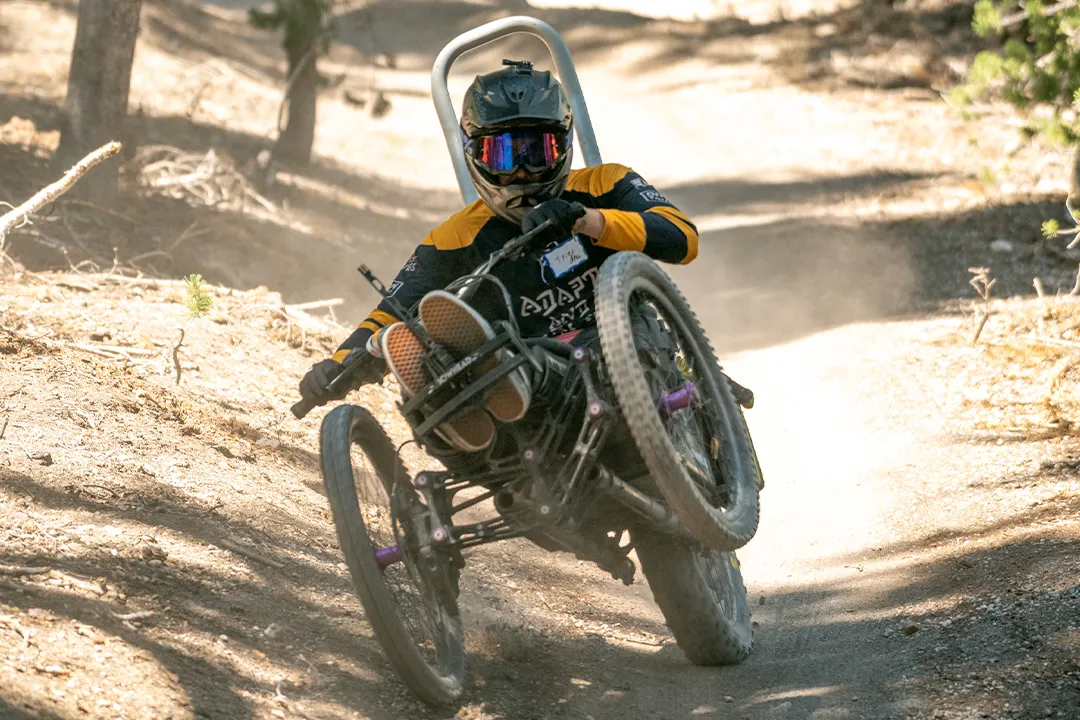Access Mammoth adaptive mountain biker on a mountain bike trail during our summer programs