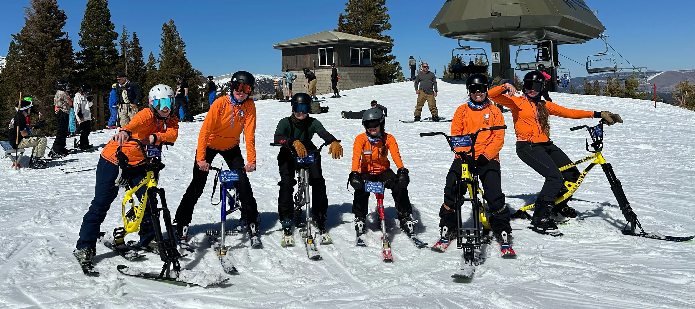 image An Access Mammoth instructor with athlete road biking down a highway smiling at the camera