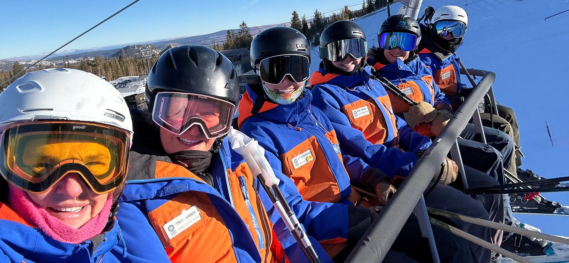 image An Access Mammoth instructor with athlete road biking down a highway smiling at the camera