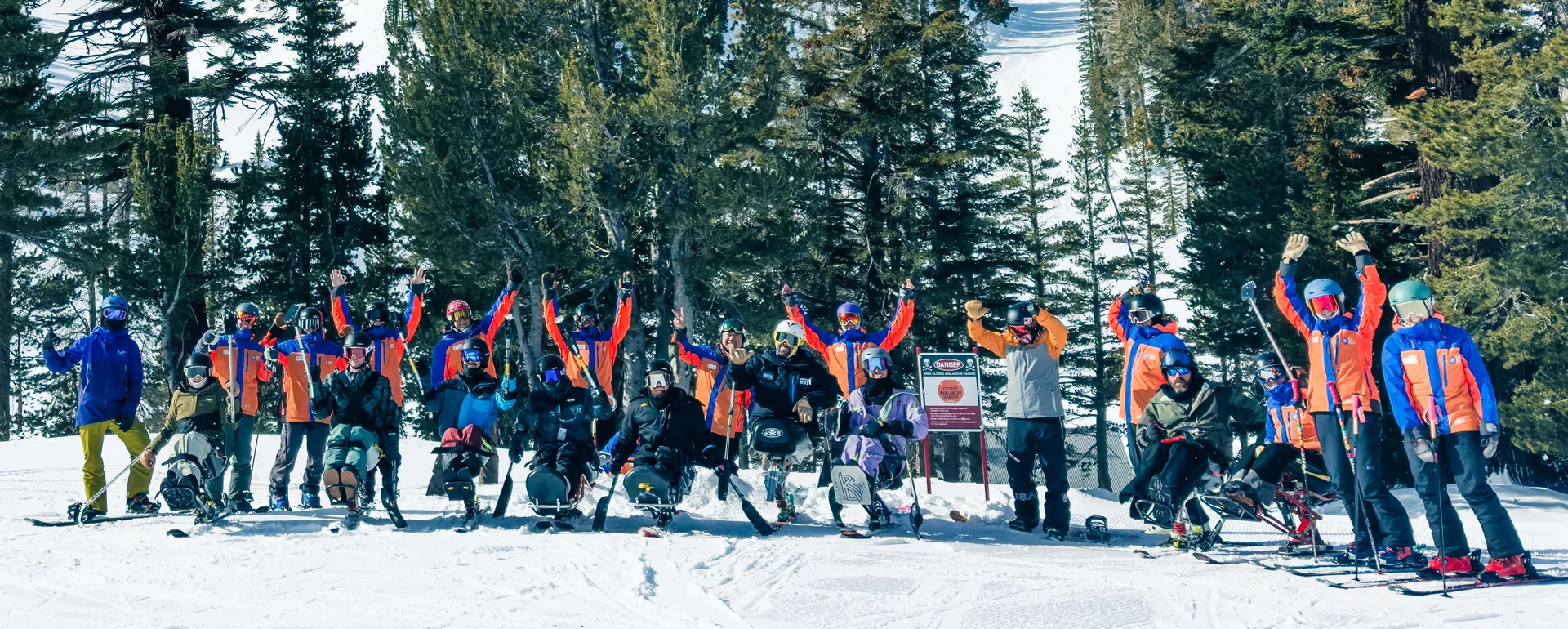 image An Access Mammoth instructor with athlete road biking down a highway smiling at the camera