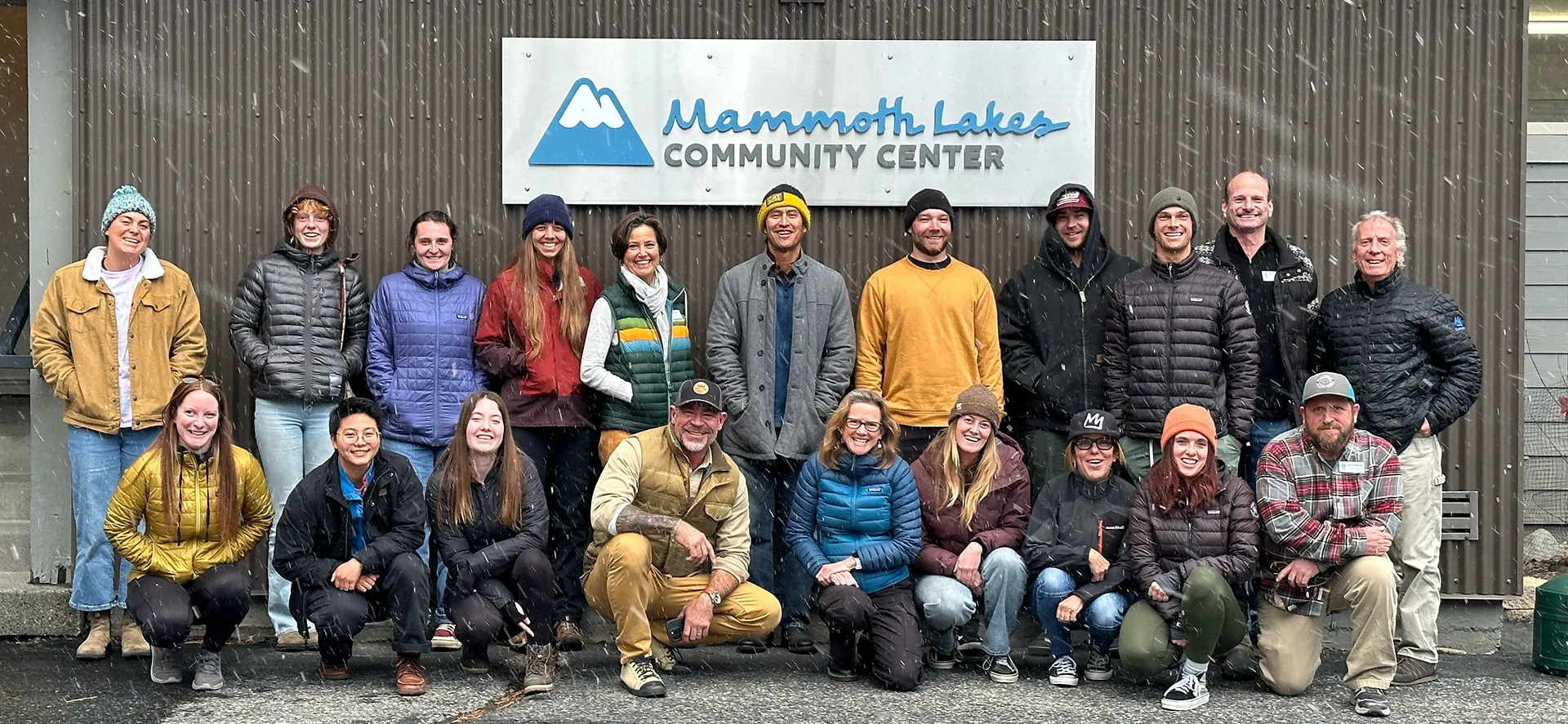 image An Access Mammoth instructor with athlete road biking down a highway smiling at the camera