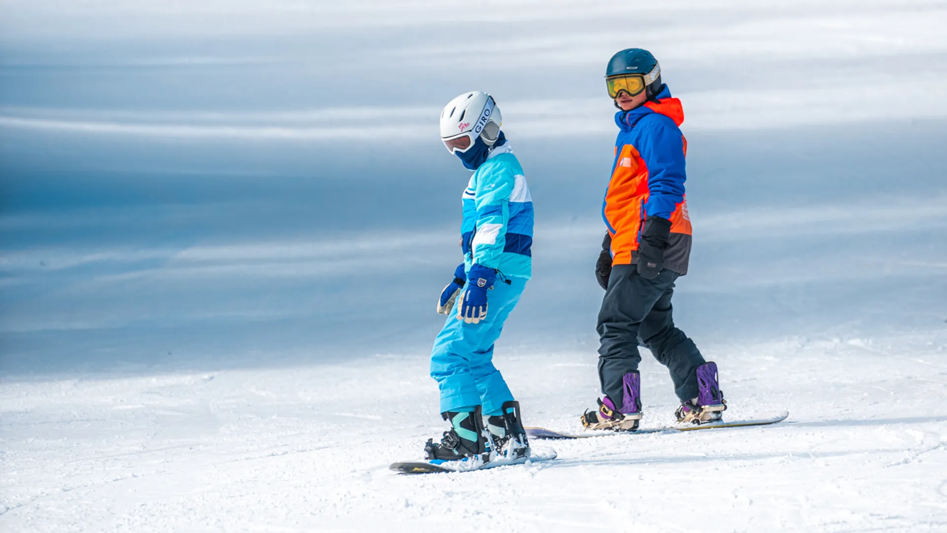 image An Access Mammoth instructor with athlete road biking down a highway smiling at the camera